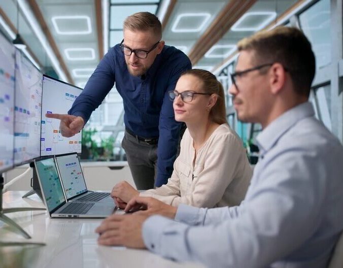 Project Manager Leads Team Using Laptop